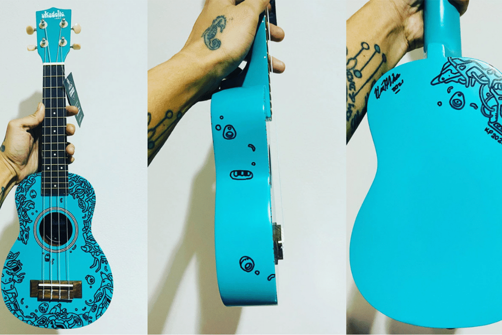 Kyar Pauk holding the custom art doodle ukulele