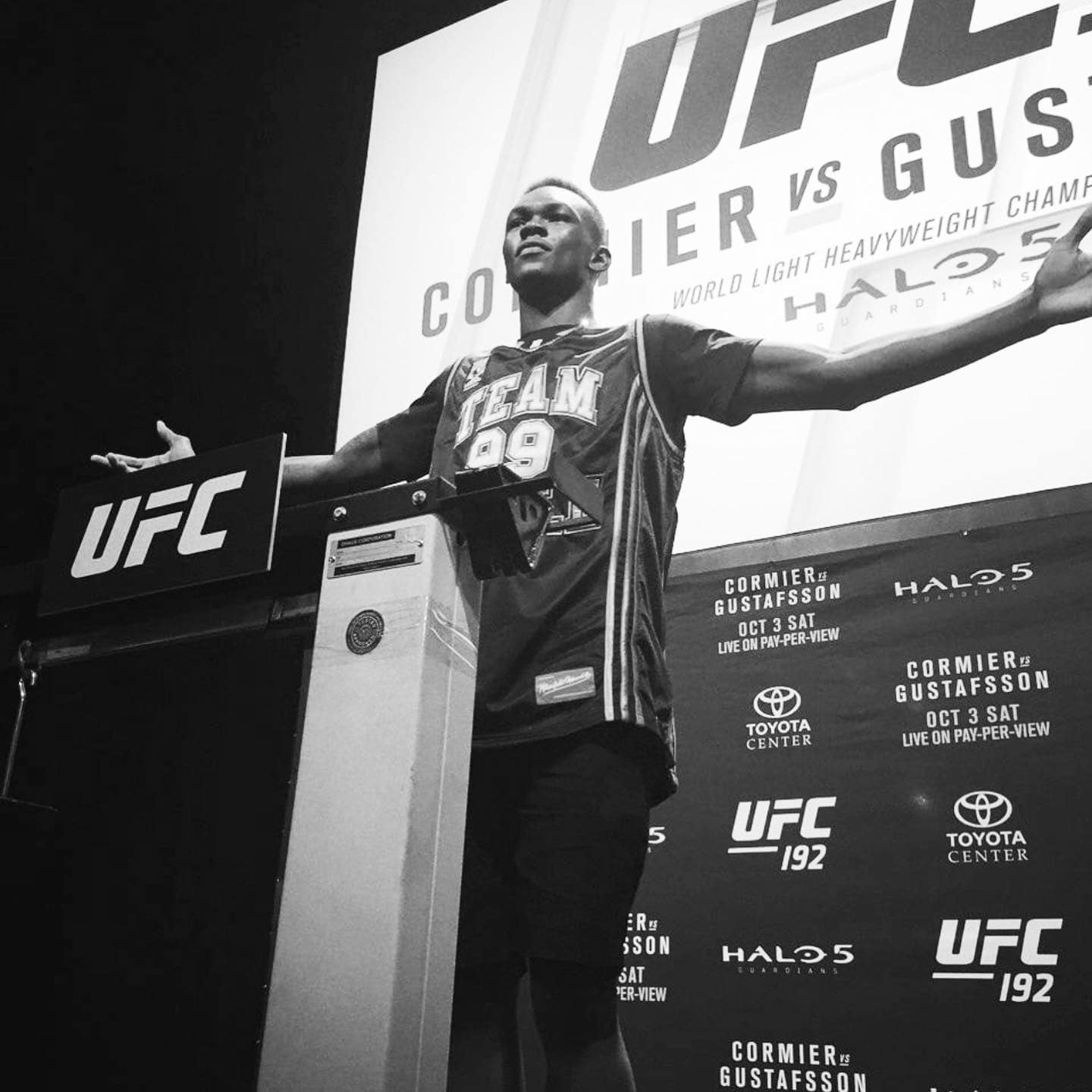 Israel Adesanya at a podium in front of a UFC backdrop