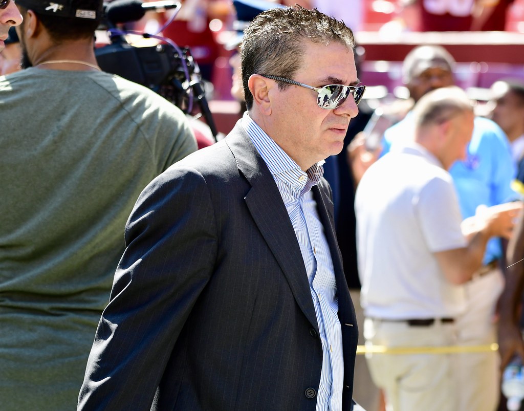 Dan Snyder, in reflective sunglasses and suit jacket