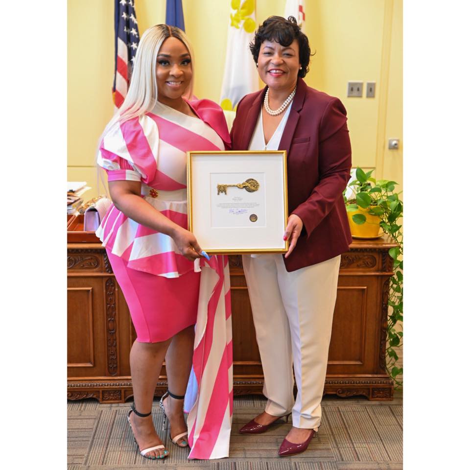 Jesseca, smiling with another woman after receiving an award