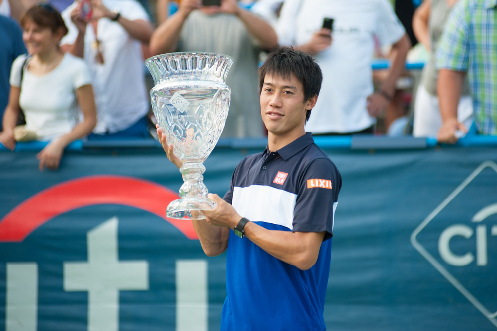 Kei Nishikori with his trophy after winning the men's finals title at the Citi Open tennis tournament