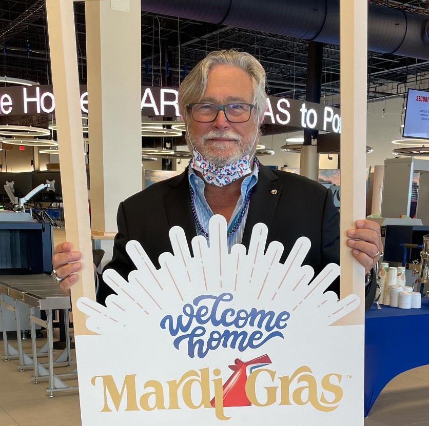 Micky Arison holding a sign