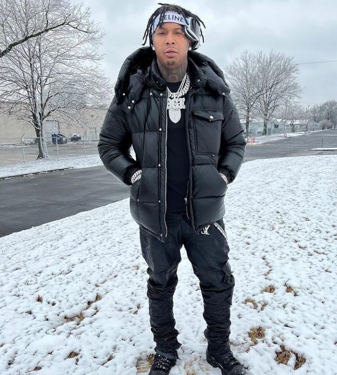 Moneybagg Yo standing in a snowy landscape