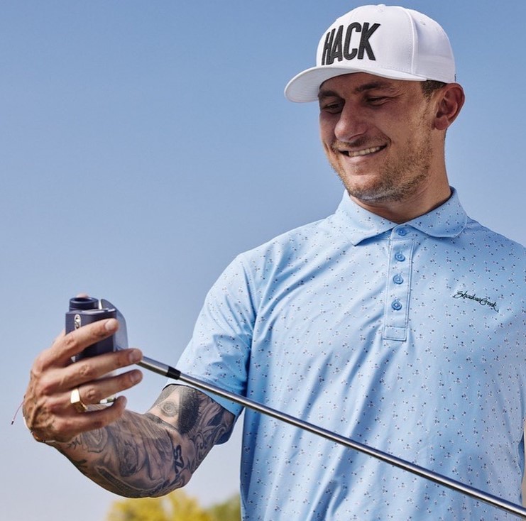 Johnny Manziel holding the head of a golf club