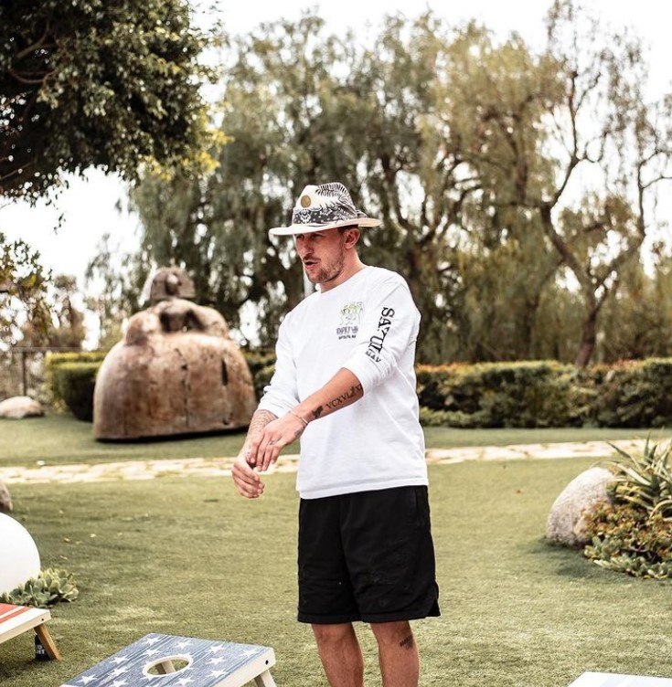 Johnny Manziel, outside in a white top and hat