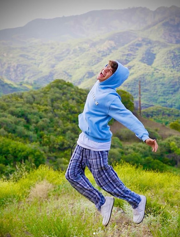 Ayden Mekus, mid-air in a blue hoodie