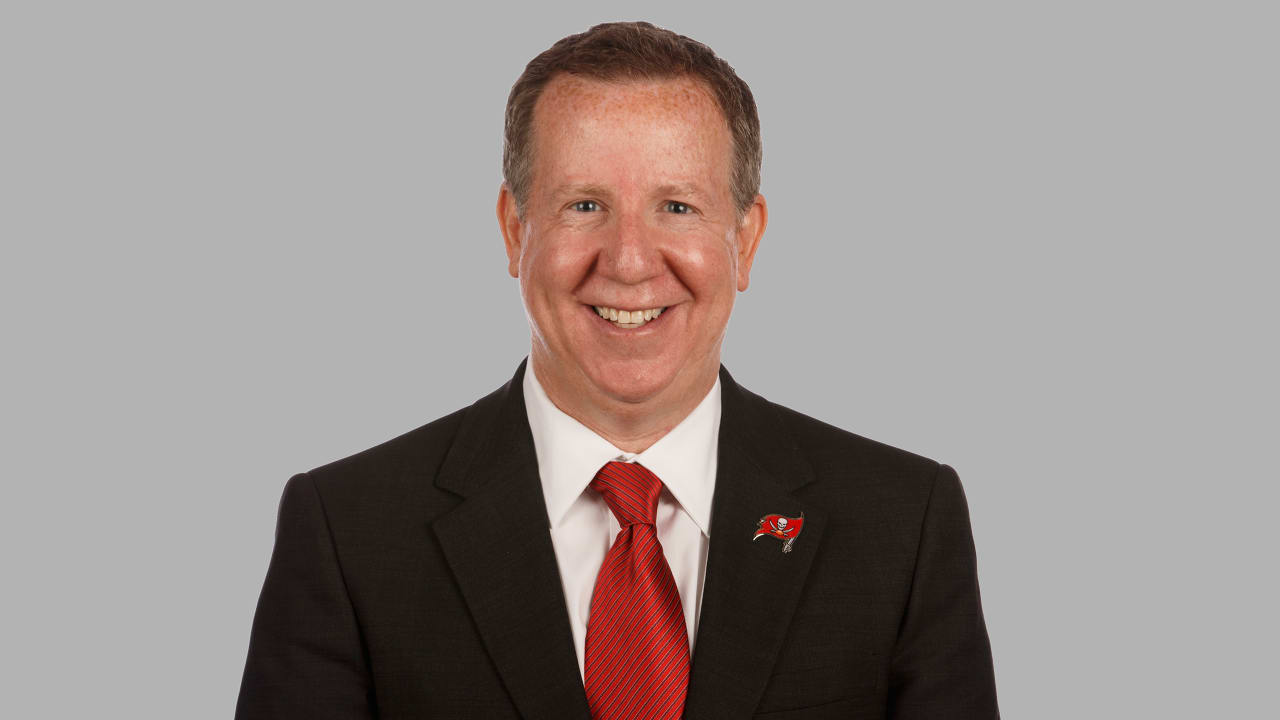 Bryan Glazer, wearing a suit and tie in front of a light background