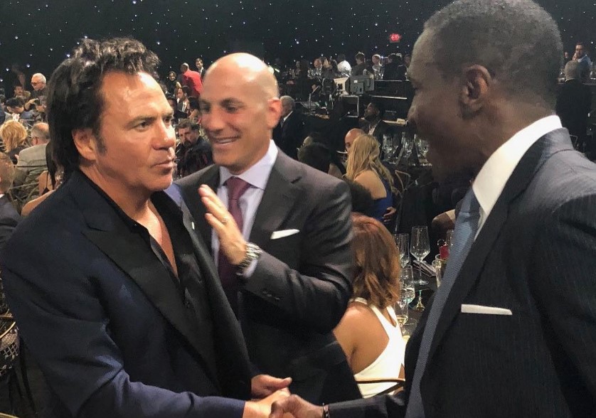 Tom Gores shaking hands with Coach Casey