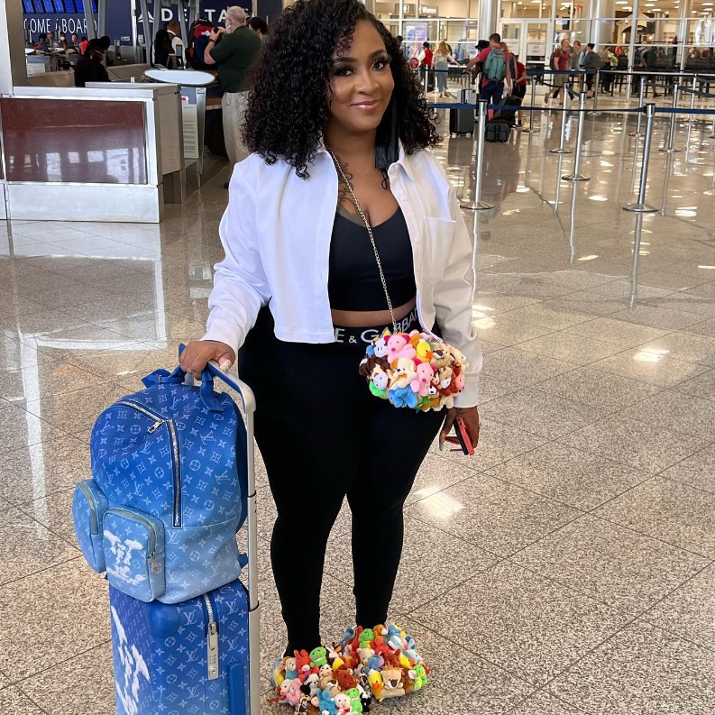 Jesseca at an airport, next to her luggage