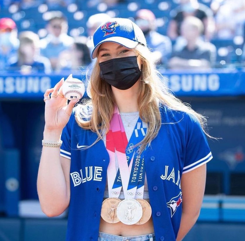 Penny, masked and holding a baseball