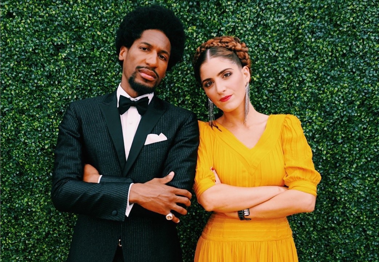 Jon Batiste and his wife, Suleika Jaouad, against greenery